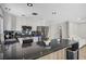 Modern kitchen boasts stainless steel appliances, black countertops, and white cabinets at 8953 Paige Rene Ct, Las Vegas, NV 89117