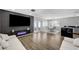 Modern living room with a sleek entertainment center, wood floors, and an open layout at 8953 Paige Rene Ct, Las Vegas, NV 89117