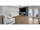 Stylish living room featuring modern decor, wood floors, and a door leading to the patio at 8953 Paige Rene Ct, Las Vegas, NV 89117