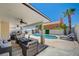 Inviting covered patio featuring a sparkling pool, comfortable seating, and lush landscaping for outdoor enjoyment at 8953 Paige Rene Ct, Las Vegas, NV 89117