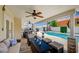 Charming covered patio area with outdoor seating, ceiling fans, and a clear view of the refreshing swimming pool at 8953 Paige Rene Ct, Las Vegas, NV 89117