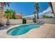 Backyard pool with palm trees, privacy wall, and lounge chairs, perfect for relaxation at 8953 Paige Rene Ct, Las Vegas, NV 89117
