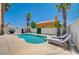 Beautiful backyard pool area featuring lounge chairs, palm trees, and a serene setting for relaxation and recreation at 8953 Paige Rene Ct, Las Vegas, NV 89117