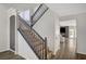 Elegant staircase with hardwood steps and black metal railings leading to the upper level at 8953 Paige Rene Ct, Las Vegas, NV 89117