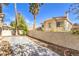 A cozy backyard with privacy wall, concrete patio and mature palm trees at 9220 Pitching Wedge Dr, Las Vegas, NV 89134