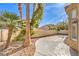 The backyard features a paved area, low-maintenance landscaping and mature palm trees at 9220 Pitching Wedge Dr, Las Vegas, NV 89134