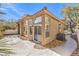 Rear view of home with stucco exterior, tile roof, and fenced backyard at 9220 Pitching Wedge Dr, Las Vegas, NV 89134