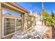 Back of home with concrete patio, privacy wall, and sliding glass doors at 9220 Pitching Wedge Dr, Las Vegas, NV 89134