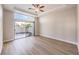 Bright bedroom with wood floors, ceiling fan, and sliding glass door to outdoor patio at 9220 Pitching Wedge Dr, Las Vegas, NV 89134
