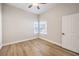 Bedroom with light-colored wood floors, two windows, and a white door at 9220 Pitching Wedge Dr, Las Vegas, NV 89134