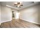 Spacious bedroom with wood floors, ceiling fan, and doorway to the bathroom at 9220 Pitching Wedge Dr, Las Vegas, NV 89134