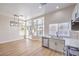 Open-concept kitchen and dining area featuring stainless steel appliances, modern lighting, and wood floors at 9220 Pitching Wedge Dr, Las Vegas, NV 89134