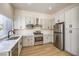 Kitchen with stainless steel appliances, white marble countertops, and updated cabinetry at 9220 Pitching Wedge Dr, Las Vegas, NV 89134