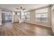 Open-concept living room featuring hardwood floors, modern ceiling fan, and ample windows at 9220 Pitching Wedge Dr, Las Vegas, NV 89134