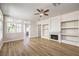 Bright living room with hardwood floors and a modern fireplace and built-in shelves at 9220 Pitching Wedge Dr, Las Vegas, NV 89134