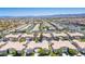 Wide aerial shot of a community with well-maintained homes, lush landscaping, and stunning mountain views at 9357 Golden Timber Ln, Las Vegas, NV 89117