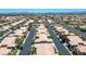 Overhead view of homes with light-colored tile roofs and tree-lined streets in a planned community at 9357 Golden Timber Ln, Las Vegas, NV 89117