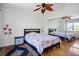 Bedroom with a leaf ceiling fan and a mirrored closet at 9357 Golden Timber Ln, Las Vegas, NV 89117