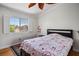 Bright bedroom featuring a window with white shutters, hardwood floors, and floral accents at 9357 Golden Timber Ln, Las Vegas, NV 89117