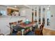 A glass table sets in the dining area, reflecting natural light from nearby kitchen at 9357 Golden Timber Ln, Las Vegas, NV 89117