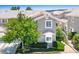 Well-maintained home with lush landscaping, mature trees, and a charming two-story facade at 9357 Golden Timber Ln, Las Vegas, NV 89117