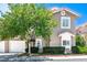 Charming townhome featuring a well-maintained front yard and attached two-car garage at 9357 Golden Timber Ln, Las Vegas, NV 89117