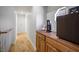 Second floor hallway with hardwood floors and a wooden cabinet on the right at 9357 Golden Timber Ln, Las Vegas, NV 89117