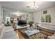 Bright living room featuring hardwood floors and a large decorative mirror wall at 9357 Golden Timber Ln, Las Vegas, NV 89117