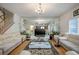 Open living room with hardwood floors, chandelier, and staircase at 9357 Golden Timber Ln, Las Vegas, NV 89117