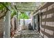 Private patio with a pergola offers shade and space for outdoor living next to a sliding glass door at 9357 Golden Timber Ln, Las Vegas, NV 89117