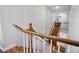 Hallway staircase with carpet steps and wood railing at 9357 Golden Timber Ln, Las Vegas, NV 89117