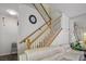 Staircase with wooden railing, light walls and furniture, and a mirror on the wall at 9357 Golden Timber Ln, Las Vegas, NV 89117