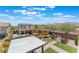 Aerial view of backyard featuring pool, covered patio, outdoor kitchen, landscaping, and mountain views at , Las Vegas, NV 89149