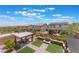 Aerial view of backyard featuring covered seating, outdoor kitchen, fire pit, landscaping, and neighboring houses at , Las Vegas, NV 89149
