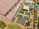 Aerial view featuring a backyard with turf, a patio, a pool, a covered area, and nice landscaping at , Las Vegas, NV 89149