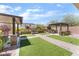 Backyard featuring manicured lawn, landscaped seating areas, and mature trees at , Las Vegas, NV 89149