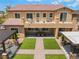 Exterior of home featuring second story patio, backyard patio, turf, and covered outdoor seating at , Las Vegas, NV 89149