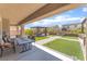 Relaxing backyard with a covered patio, an outdoor dining area, and artificial grass at , Las Vegas, NV 89149