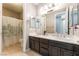 Bathroom featuring double sinks, a large mirror, and a shower with a decorative curtain at , Las Vegas, NV 89149