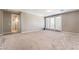 Spacious bedroom with plush carpeting, ensuite bathroom, and sliding door to balcony at , Las Vegas, NV 89149