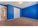 Spacious bedroom with bright blue walls and a closet for storage at , Las Vegas, NV 89149