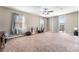 Bright bedroom featuring a ceiling fan, plush carpet, and a door to a balcony at , Las Vegas, NV 89149