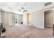 Large bedroom featuring plush carpet, a ceiling fan, and sliding door access to a balcony at , Las Vegas, NV 89149