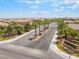 Welcoming gated community entrance with lush landscaping and palm trees under a blue sky at , Las Vegas, NV 89149