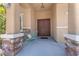 Charming front porch with double doors, stone columns, and a decorative butterfly bench at , Las Vegas, NV 89149