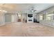 Spacious living room with cozy fireplace, large windows, plush carpet, and staircase access at , Las Vegas, NV 89149