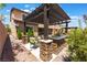 Covered outdoor kitchen featuring a built-in grill and stone accents, perfect for outdoor entertaining in style at , Las Vegas, NV 89149