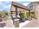 Covered patio in a backyard with an outdoor kitchen, seating, and views of the landscape at , Las Vegas, NV 89149