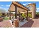 Inviting covered patio with an outdoor fireplace and comfortable seating, perfect for relaxation and entertaining at , Las Vegas, NV 89149