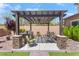An inviting patio with an outdoor grill, a built-in seating area, and a pergola at , Las Vegas, NV 89149